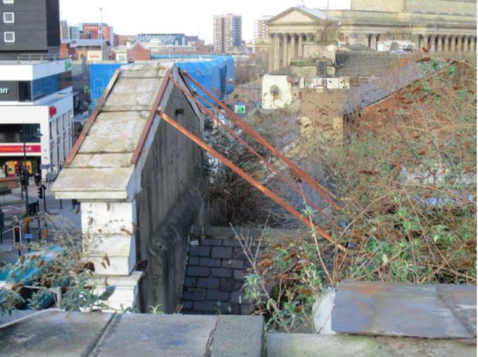 The pediment is currently held by restraining straps. While Thus I do consider that the pediment section is vulnerable, particularly in strong wind conditions.